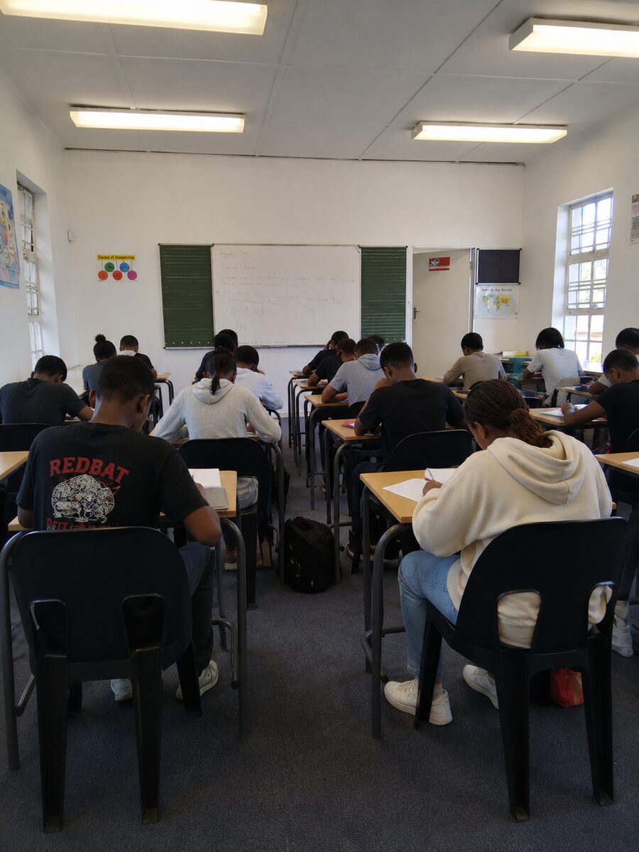 Students seated in rows completing written work